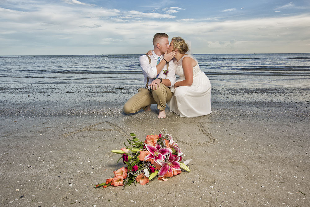 Beach wedding photography with flowers by Chris Kovaz