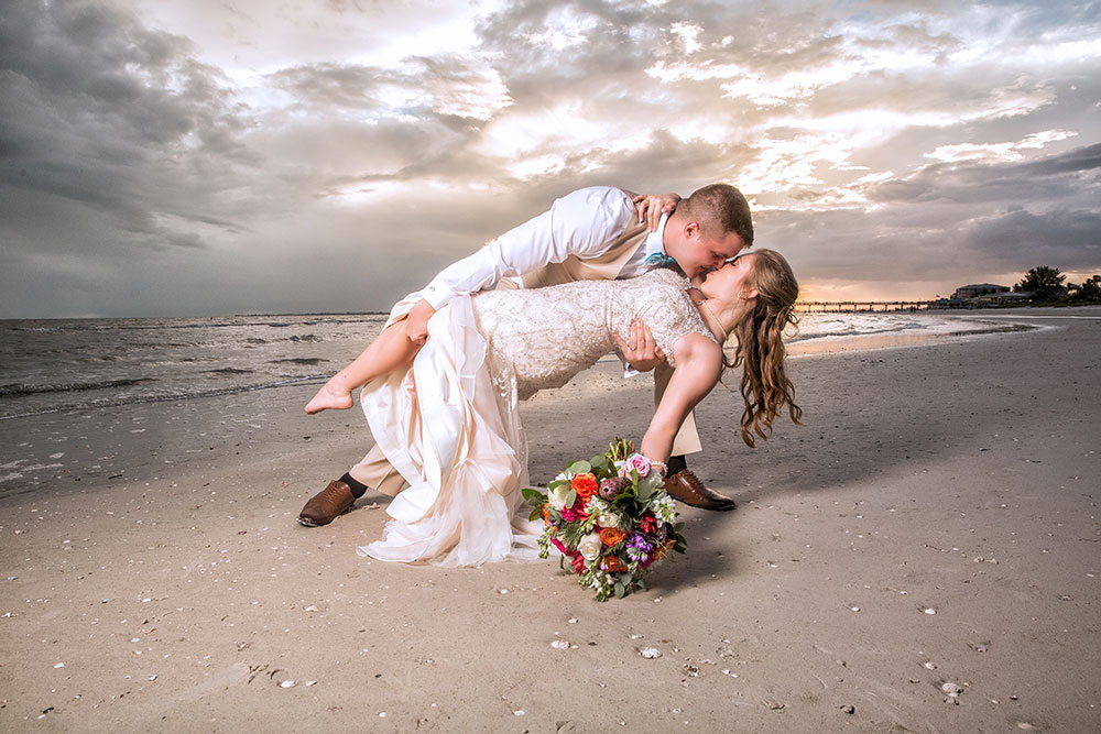 Beach wedding photos with flowers by Chris Kovaz